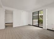 Thumbnail 53 of 92 - an empty living room with a sliding glass door to a balcony at AVIA Lofts on Parkway Apartments, Washington