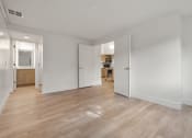Thumbnail 47 of 92 - a living room and kitchen with wood floors and white walls at AVIA Lofts on Parkway Apartments, Washington, 98662