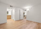 Thumbnail 46 of 92 - a living room and kitchen with wood flooring and white walls at AVIA Lofts on Parkway Apartments, Washington