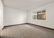 Thumbnail 44 of 92 - the living room of an empty apartment with a window at AVIA Lofts on Parkway Apartments, Washington