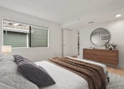 Thumbnail 22 of 92 - A bedroom with a bed, a dresser, and a mirror.