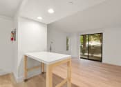 Thumbnail 48 of 92 - a kitchen with a white counter top and a sliding glass door at AVIA Lofts on Parkway Apartments, Vancouver, Washington