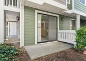 Thumbnail 69 of 92 - the front porch of a green house with a glass door at AVIA Lofts on Parkway Apartments, Vancouver