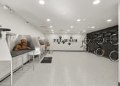 Thumbnail 31 of 92 - a dog sitting on a desk in a gym with bikes in the background at AVIA Lofts on Parkway Apartments, Vancouver, 98662