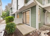 Thumbnail 70 of 92 - the entrance to a green house with a sidewalk and a glass door at AVIA Lofts on Parkway Apartments, Washington
