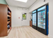 Thumbnail 26 of 92 - a room with two refrigerators and a counter with a door at AVIA Lofts on Parkway Apartments, Vancouver