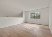 Thumbnail 60 of 92 - the living room of an empty house with wood floors and a window at AVIA Lofts on Parkway Apartments, Vancouver, WA, 98662