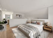 Thumbnail 20 of 92 - A bedroom with a large bed and a wooden nightstand. at AVIA Lofts on Parkway Apartments, Vancouver, WA