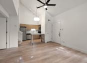Thumbnail 58 of 92 - an empty living room and kitchen with a ceiling fan at AVIA Lofts on Parkway Apartments, Vancouver, Washington
