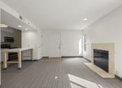 Thumbnail 66 of 92 - an empty living room with a fireplace and a kitchen at AVIA Lofts on Parkway Apartments, Washington