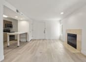 Thumbnail 64 of 92 - an empty living room with a fireplace and a kitchen at AVIA Lofts on Parkway Apartments, Vancouver, Washington