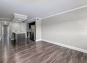 Thumbnail 29 of 41 - an empty living room and kitchen with wood flooring