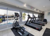Thumbnail 18 of 41 - the gym is equipped with cardio equipment and a view of the pool