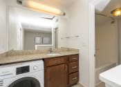 Thumbnail 70 of 108 - a kitchen with a sink and a washer and dryer