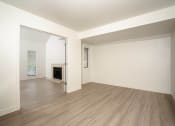 Thumbnail 64 of 108 - a bedroom with a fireplace and hardwood floors