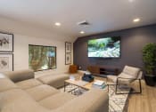 Thumbnail 13 of 108 - a living room with a large screen tv on the wall