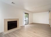 Thumbnail 63 of 108 - a bedroom with a fireplace and hardwood floors