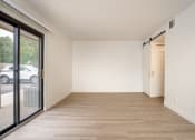 Thumbnail 66 of 108 - a bedroom with a sliding glass door and hardwood floors