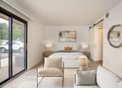 Thumbnail 48 of 108 - a bedroom with a large bed and sliding glass doors