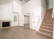 Thumbnail 55 of 108 - a living room with stairs and a fireplace