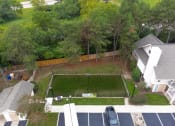 Thumbnail 9 of 108 - an aerial view of a yard with a tennis court and a house in the background