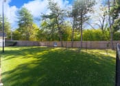Thumbnail 12 of 108 - the backyard has a fenced in area with grass and trees
