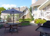 Thumbnail 5 of 108 - a patio with a table and chairs and an umbrella
