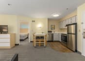Thumbnail 96 of 108 - a kitchen and dining area in a hotel room
