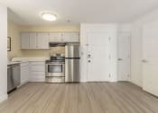 Thumbnail 89 of 108 - an empty kitchen with stainless steel appliances and white cabinets