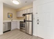 Thumbnail 92 of 108 - a kitchen with stainless steel appliances and white cabinets