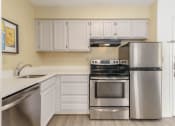 Thumbnail 93 of 108 - a kitchen with stainless steel appliances and white cabinets