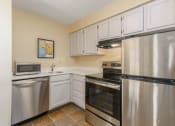 Thumbnail 87 of 108 - a kitchen with stainless steel appliances and white cabinets
