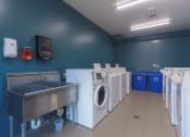 Thumbnail 32 of 108 - a laundry room with washes and washing machines and a sink