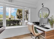 Thumbnail 26 of 61 - a home office with a large window and a desk with a computer at AVIA Lofts on Liberty Ridge, Florida, 32256