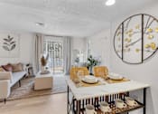 Thumbnail 5 of 61 - a living room and dining room with a table and chairs at AVIA Lofts on Liberty Ridge, Florida