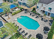 Thumbnail 37 of 61 - A swimming pool surrounded by black umbrellas and chairs.