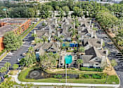 Thumbnail 15 of 61 - an aerial view of a neighborhood with houses and a swimming pool at AVIA Lofts on Liberty Ridge, Jacksonville, FL