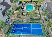 Thumbnail 14 of 61 - an aerial view of a tennis court and a pool in a house at AVIA Lofts on Liberty Ridge, Florida, 32256