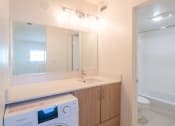 Thumbnail 19 of 34 - a dryer in a bathroom with a sink and a toilet