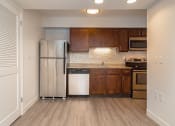 Thumbnail 50 of 108 - a kitchen with wooden cabinets and stainless steel appliances
