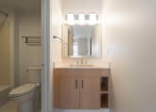 Thumbnail 74 of 108 - a bathroom with a sink and a toilet and a mirror