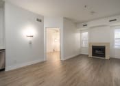 Thumbnail 79 of 108 - an empty living room with a fireplace and wood flooring
