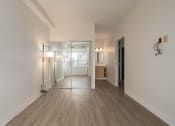 Thumbnail 82 of 108 - an empty living room with a mirrored closet and a bathroom