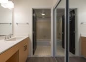 Thumbnail 80 of 108 - a bathroom with a sink and a shower and a mirror