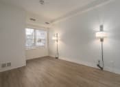 Thumbnail 86 of 108 - an empty living room with a window and two floor lamps
