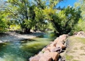 Thumbnail 47 of 50 - a river running next to a stone wall at The View on 20th, Ogden, Utah