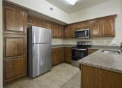 Thumbnail 23 of 46 - a kitchen with a refrigerator stove and microwave at Siena Villas Apartments, Orem, UT, 84097