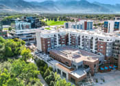 Thumbnail 1 of 71 - an aerial view of a large apartment complex with a golf course in the background at Wilmington Flats Apartments, Utah