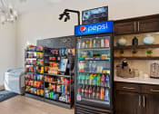 Thumbnail 35 of 83 - a cooler in a store with a refrigerator and a counter with drinks at 200 City View, Provo, Utah