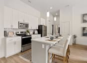 Thumbnail 50 of 83 - an open kitchen and dining area with a table and chairs at 200 City View, Provo, UT, 84601